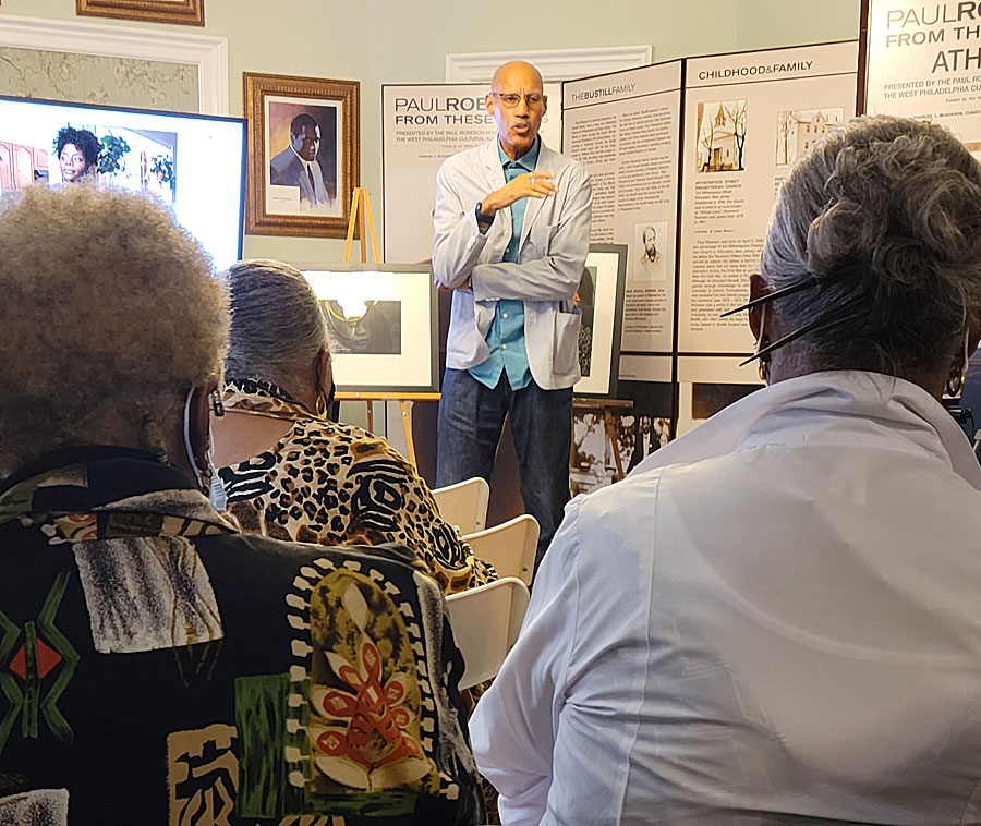 Raymond W. Holman Jr. tells a story behind one of his photos. Photo by Sherry L. Howard. 